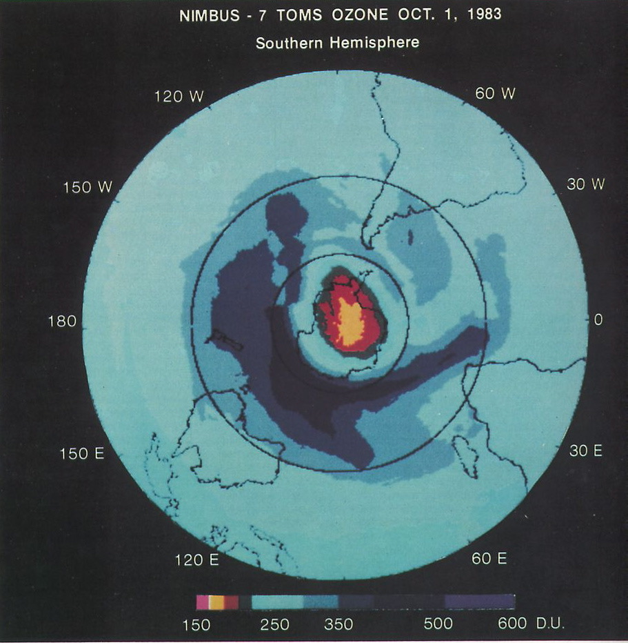 A circular false-colour map of ozone over the southern hemisphere, with a red and yellow patch of very low values over Antarctica