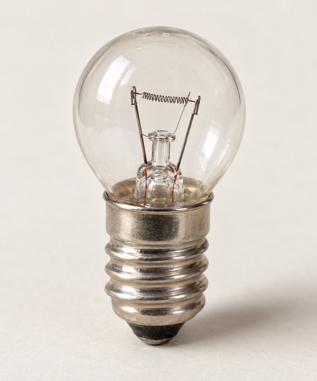 Clear glass filament lamp with a visible coiled wire inside