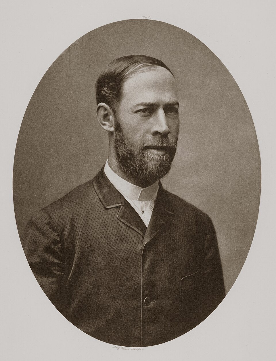 Photograph of Heinrich Hertz, a young man with a beard and mustache in a dark suit