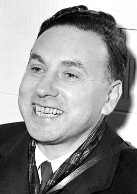 Portrait of Robert Hofstadter, a smiling man in a suit