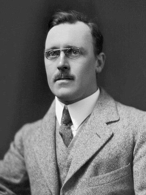 Portrait of Ernest Marsden, a man with glasses in a suit