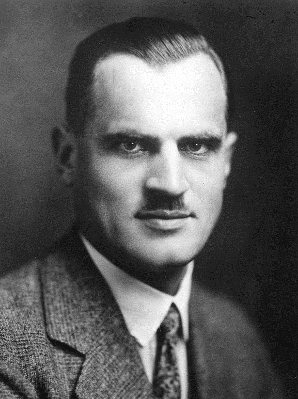 Portrait of Arthur Compton, a man with a mustache in a tweed suit