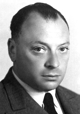 Photographic portrait of Wolfgang Pauli, a man with dark hair in a suit and tie